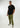 Tall man modeling a black T-shirt with olive green pants and white sneakers