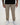Beige pants for tall men styled with a black T-shirt and white sneakers