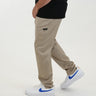 Tall man wearing beige pants with black T-shirt and white sneakers