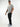 Tall man wearing black pants with light grey T-shirt and blue-and-white sneakers