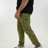 Tall man wearing olive green pants with black T-shirt and matching sneakers